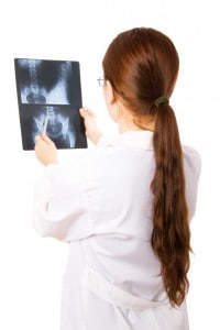Female doctor examining a pelvis x ray